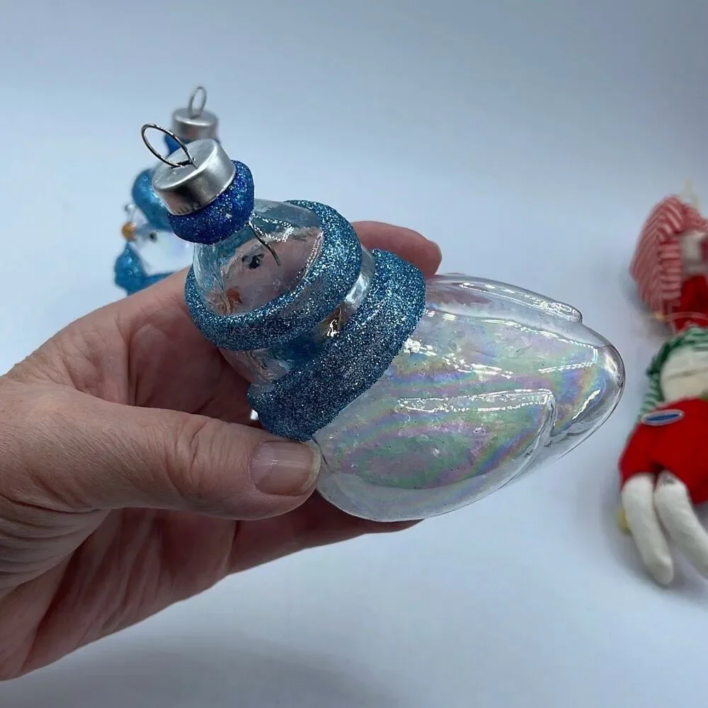 Lot of 2 glass chickadee ornaments with scarves and hats. Faux snow in bottoms.